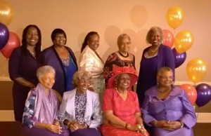 A group of women in purple and pink outfits.