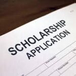 A scholarship application is shown on top of the table.