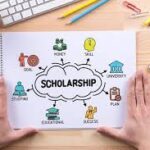 A person holding onto a scholarship page