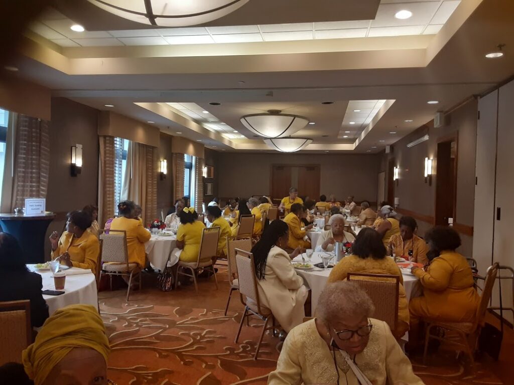 A group of people sitting at tables in a room.