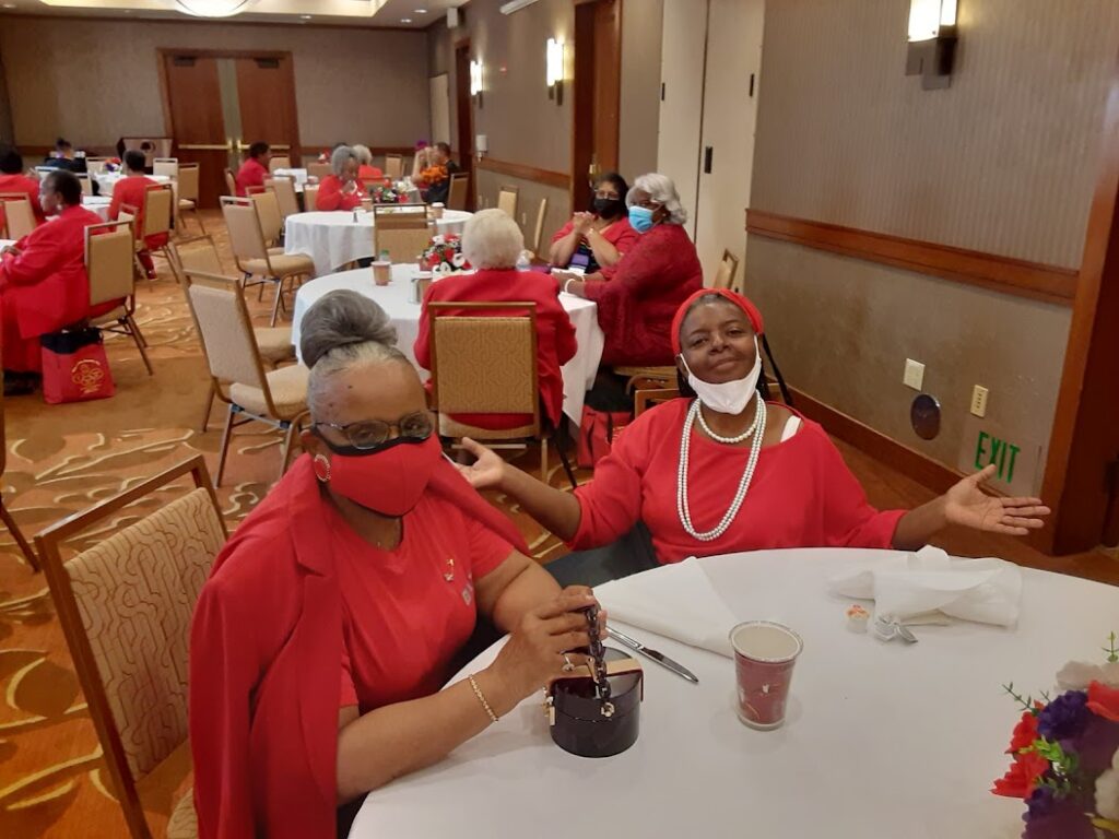 Two women sitting at a table with drinks.