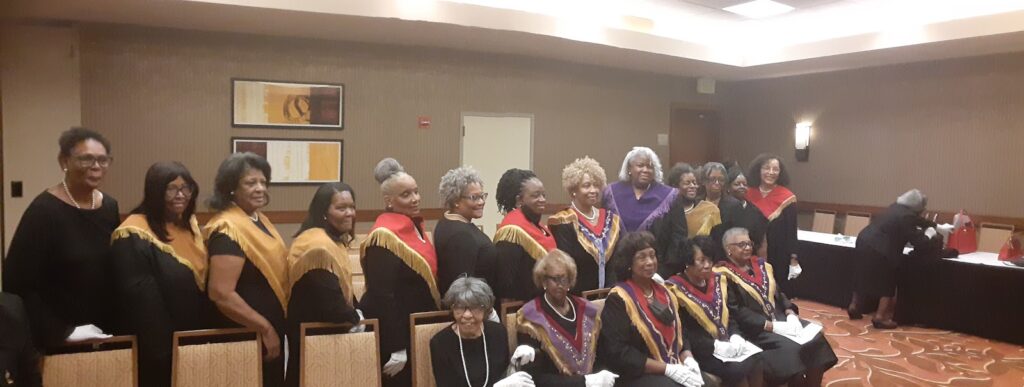 A group of women in black robes and white gloves.