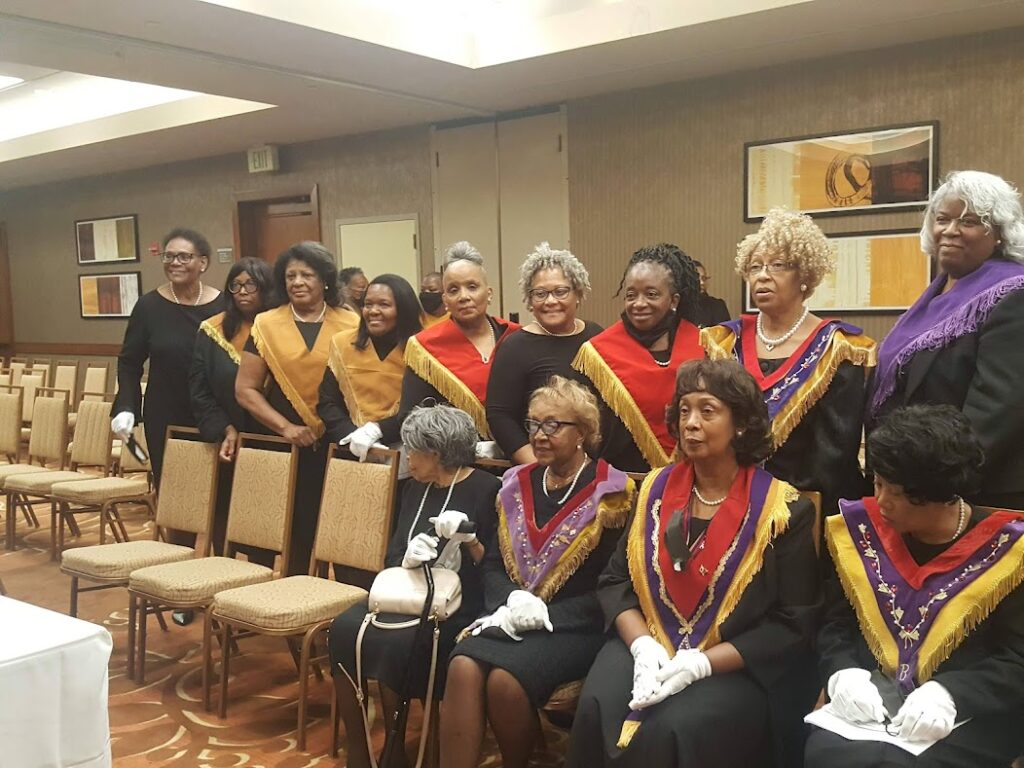 A group of people in black and yellow robes.