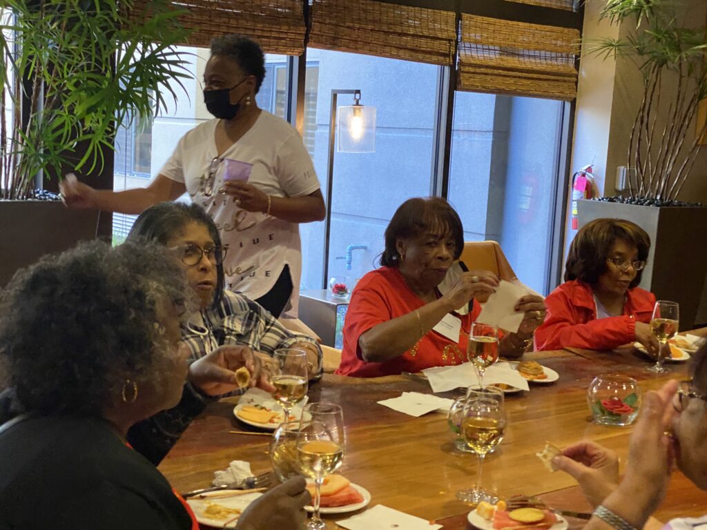 A group of people sitting at a table with food.