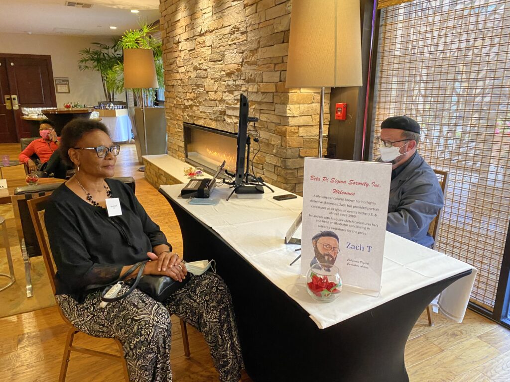 A woman sitting at the reception desk of a hotel.