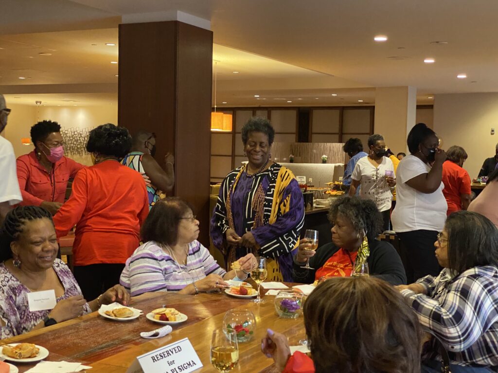 A group of people sitting at a table eating food.