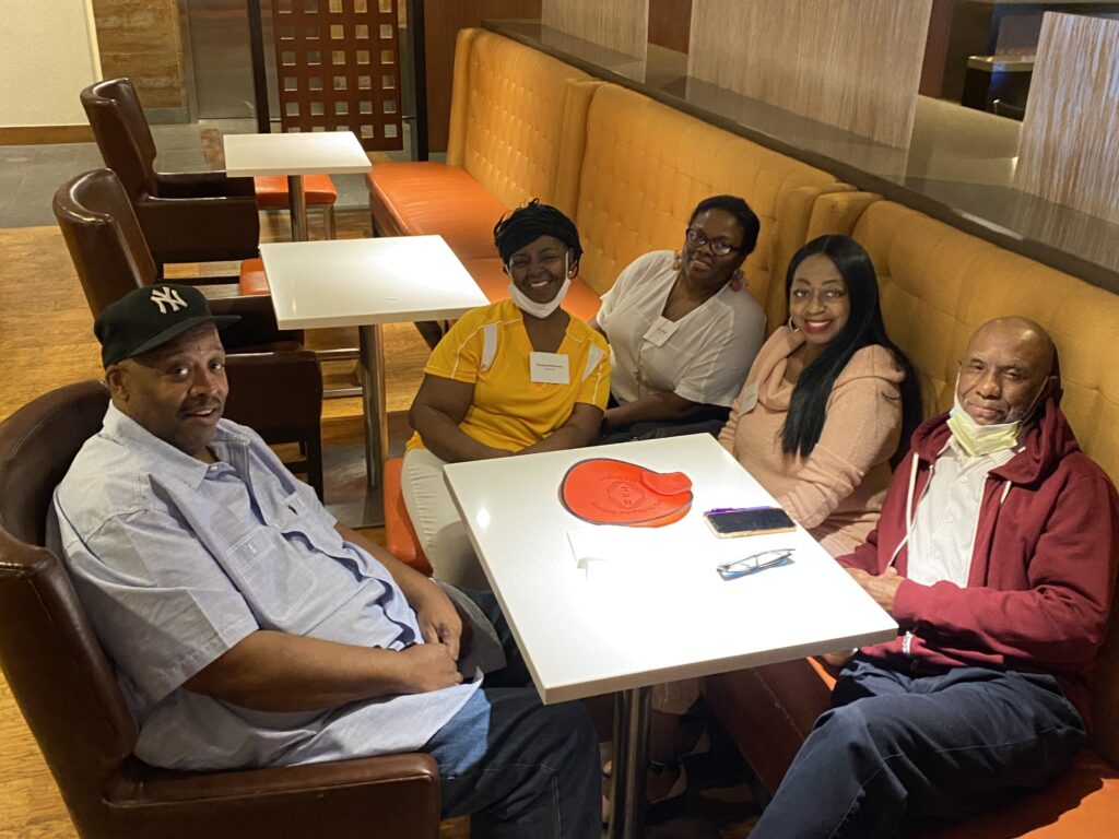 A group of people sitting at a booth in a restaurant.