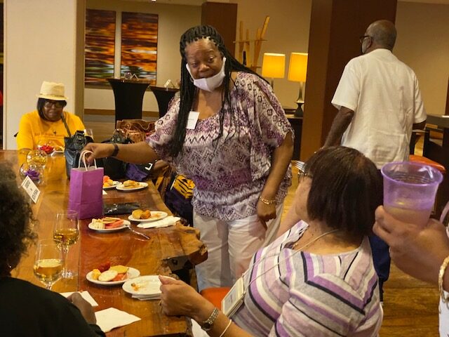 A woman wearing a face paint standing at the table.