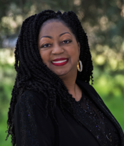 A woman with long black hair and red lipstick.