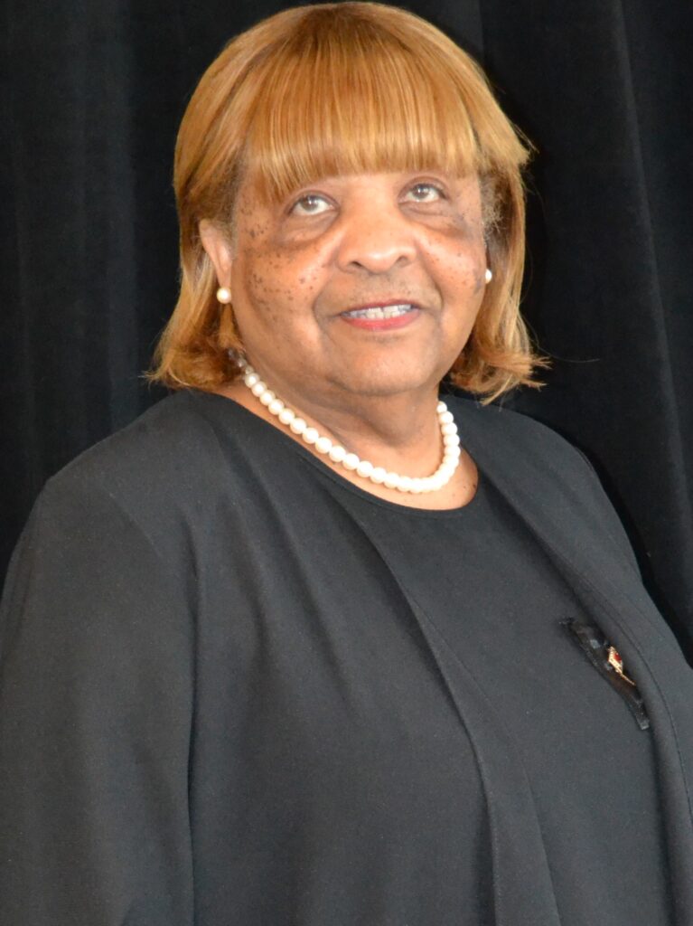 A lady with brown hairs looking at the camera